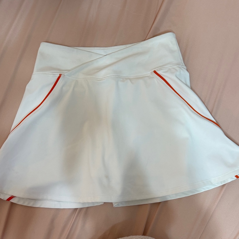 White tennis skirt with orange detailing